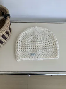 Detailed view of the Korean retro hollow knit beanie in off-white, featuring textured pattern.