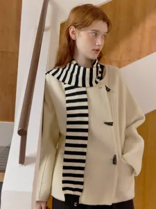 Chic black and white striped knitted scarf paired with elegant cream duffle coat.