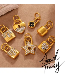 Close-up of gold lock-shaped rhinestone charms and star pendants for jewelry making