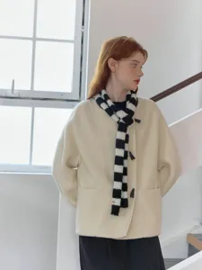 Stylish long narrow knit scarf featuring a chic black and white color block design for daily wear.