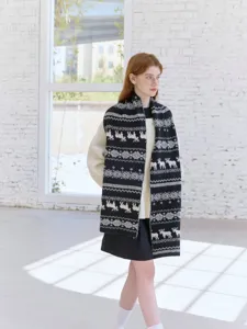 Close-up scene of retro Fair Isle moose knit scarf worn by model, cozy winter style.