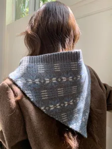 Close-up detail of the vintage Fair Isle knit triangular scarf, showing textured jacquard pattern.