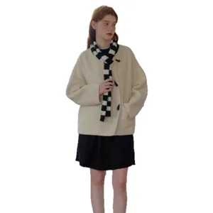 Stylish black and white checkered scarf paired with beige coat and black skirt fashion outfit.