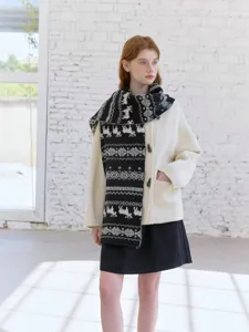 Detail view of women's Fair Isle knit scarf with classic elk jacquard pattern for winter warmth.