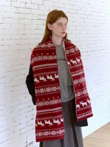 Detail view of red and white Fair Isle elk knit scarf, featuring cozy winter Nordic pattern.