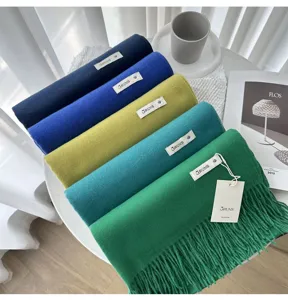 Solid color cashmere scarf detail, warm winter tassel shawl, elegant fashion wear.