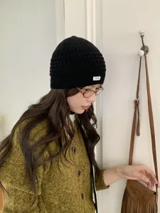Korean style black knitted hollow beanie, soft warm winter hat detail shot for cozy daily wear.