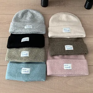 Detailed view of cozy knit winter beanies in multiple colors, thick double-layer warm wool blend.
