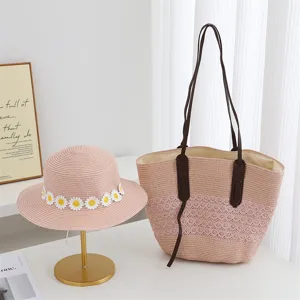 Detailed view of the pink straw sun hat with daisy flowers and matching straw tote bag.
