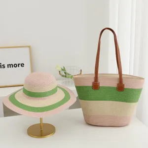 Close-up detail of summer striped straw hat and tote bag set for beach vacation style.
