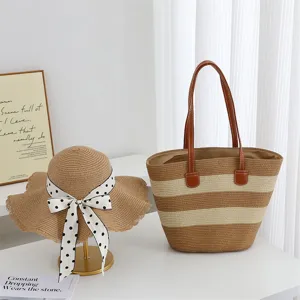 Detail shot of a stylish straw tote bag and a chic ribbon-decorated sun hat for summer.