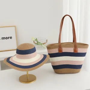 Detailed view of women summer straw woven hat and stripe shoulder bag set for beach vacation.