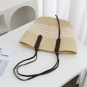 Stylish woven straw tote bag with lace detail and brown leather straps for women daily use.