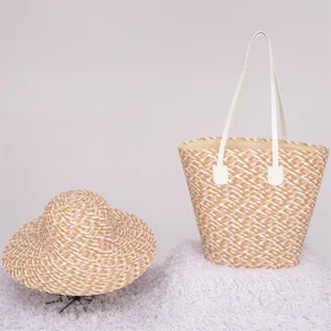 Detailed view of the stylish straw tote bag and matching beach hat with contrast color weave.
