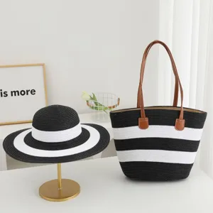 Black and white striped straw sun hat and matching shoulder tote bag for summer beach travel.