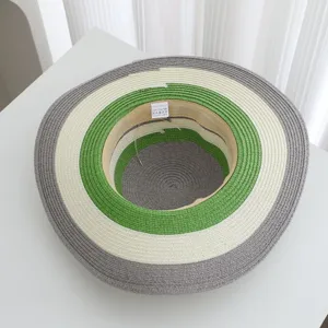 Detailed view of the striped straw hat showing multi-color concentric circles for summer beach