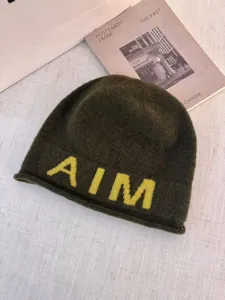 Dark green knit beanie hat for women, cozy winter warm pullover cap with yellow AIM letters