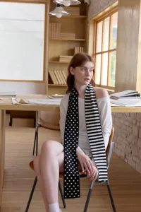 Cozy black and white knit scarf featuring a chic polka dot and striped split design for women.