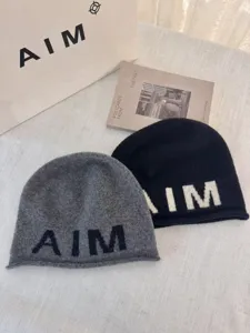 Stylish wool blend knit beanie for women, soft warm winter slouchy hat with chic letter design.