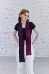 Detailed view of soft knit scarf featuring a unique split design with polka dots and stripes.
