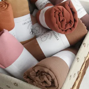 Cozy solid color cotton crinkle scarf for women, stylish warm winter neck wrap accessory.