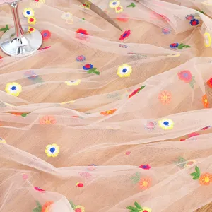 Embroidered tulle table runner featuring delicate daisy mesh design for elegant home decor and events.