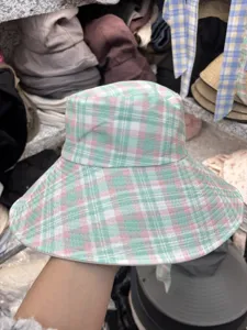 Detailed view of the stylish green and pink plaid bucket hat with wide brim for women summer.