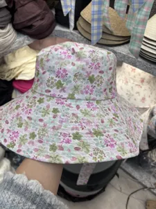 Detail view of a floral print bucket hat with a wide brim, casual style for women and girls.