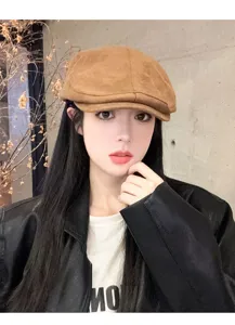 Detailed view of women brown suede newsboy cap, chic chic fall autumn fashion streetwear hat style.