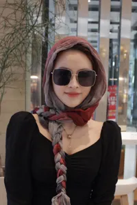 Close up detail of women gradient red grey braided headscarf, soft stylish fashion headwrap.