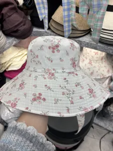 Floral print bucket hat detail showcasing the soft fabric and delicate pink rose pattern clearly.