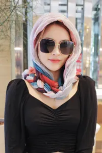Detailed view of the stylish handmade braided multi-color headscarf worn by an Asian model.