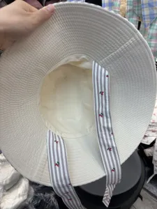 Oversized wide brim bucket hat with striped cherry print straps for women stylish spring outdoor.