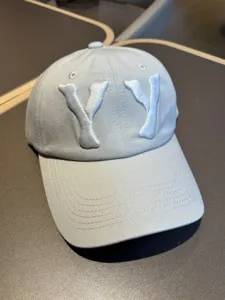 Detail shot of light grey washed baseball cap with raised 3D embroidered YY letters.