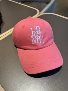 Pink cotton baseball cap with white embroidered letters, casual curved brim sun hat for women.