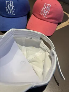 Close-up detail of casual embroidered baseball cap with adjustable strap and inner label.