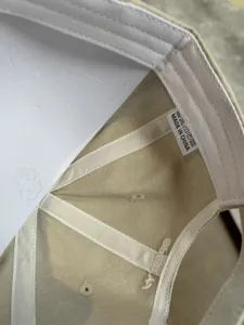 Detailed view of the washed vintage cotton baseball cap inner structure and embroidery.