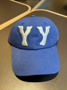Washed distressed blue baseball cap with white YY embroidery detail for casual streetwear style.