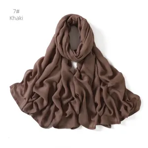 Close-up detail view of the soft khaki modal cotton scarf, showing fine texture and drapes.