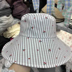 Oversized brim bucket hat for women with grey white stripes and cute cherry print sun hat.