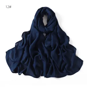 Detailed view of a dark blue modal cotton scarf, showing soft texture and fine stitching.