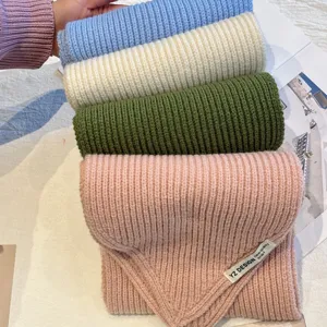 Detailed view of chunky knit short winter scarf in multi colors, soft and cozy neck warmer.