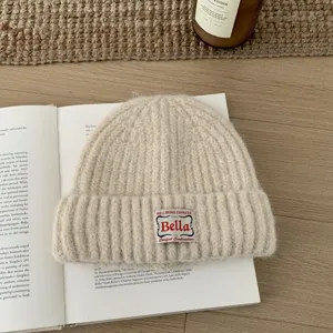 Cozy knitted beanie hat for women, winter warm woolen pullover cap with woven patch.