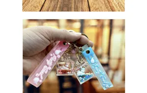 Closeup detail of liquid glitter unicorn keychain pendant with cute perfume bottle design.
