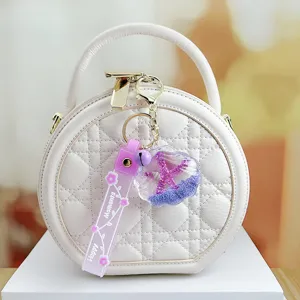 Quilted round handbag featuring a cute starfish liquid glitter keychain with strap.