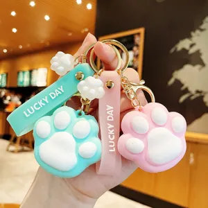 Cute cat paw keychain charm for bags, soft silicone material with sweet pink and green colors.