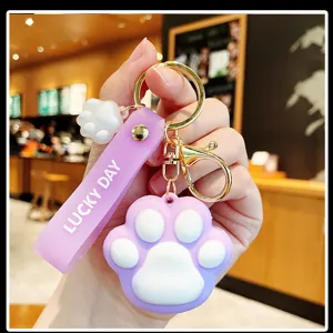 Cute cat paw keychain with purple strap, bag pendant and stylish car key accessory for girls.