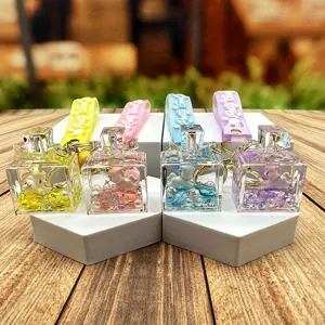 Cute liquid quicksand unicorn perfume bottle keychain pendant with colorful silicone strap.