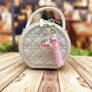 White quilted round handbag with cute liquid unicorn keychain stylish shoulder bag for women