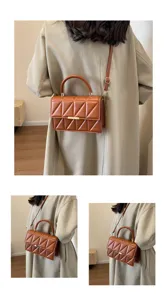 Detailed view of the brown quilted leather shoulder bag, showcasing its stylish design and hardware.
